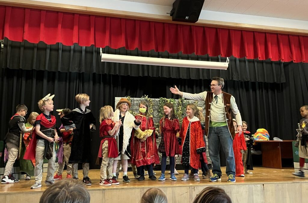 Children performing drama on stage